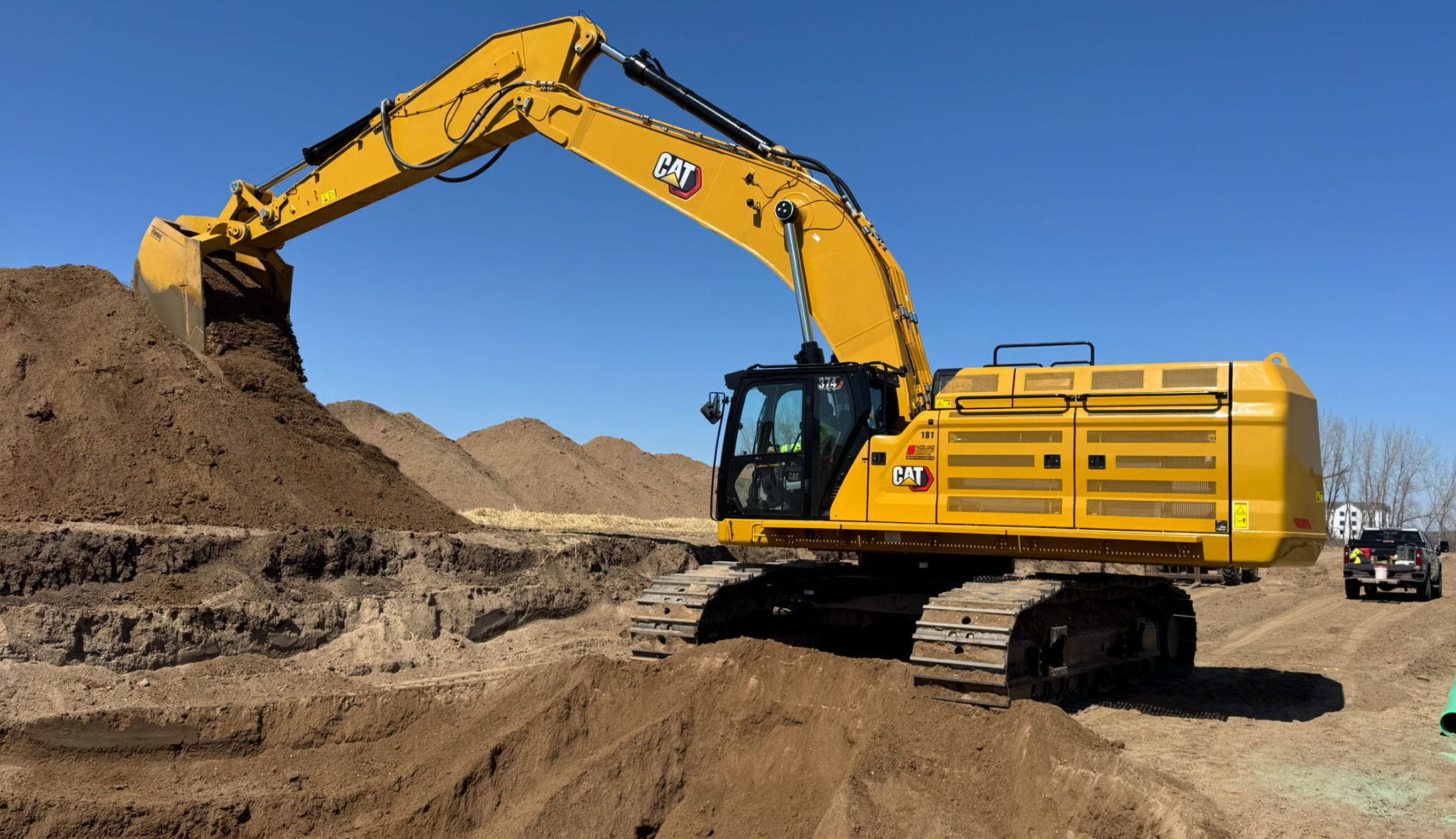 Nodland Construction excavator moving dirt for Vermillion Commons in Farmington, MN